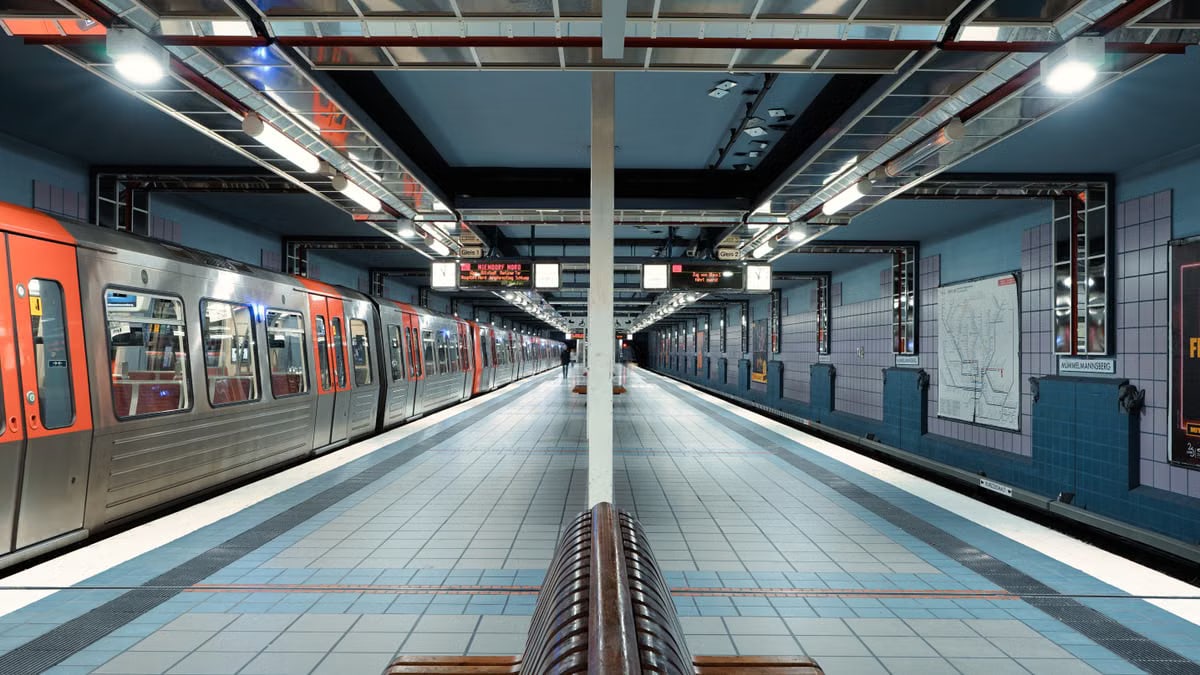 A quiet and modern subway station in Hamburg, showcasing sleek architecture and trains.